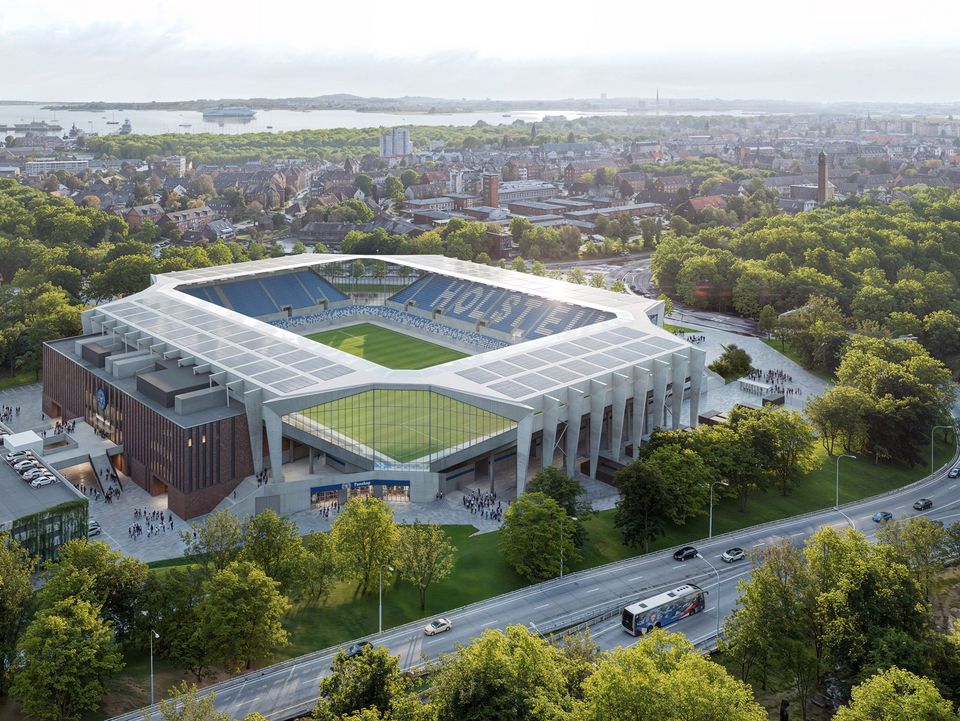 Luftaufnahme des Stadions mit deutlich erkennbarer Dachstruktur, umlaufender Tribünenform, Eingangsbereichen und umgebender Stadtlandschaft.