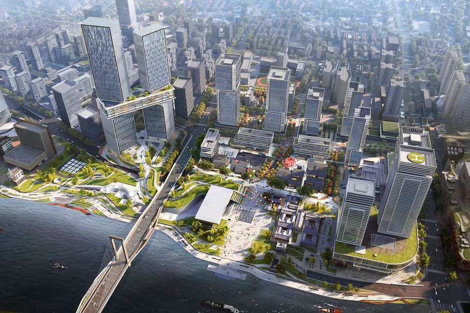 Luftvisualisierung eines urbanen Flussuferquartiers mit Hochhausclustern, terrassierten Landschaftsräumen, Brückenanbindung und öffentlichen Freiflächen entlang der Wasserfront.