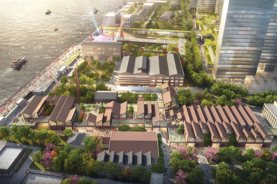 Luftvisualisierung eines Uferquartiers mit gemischt genutzten Gebäuden, historischen Hallenstrukturen, begrünten Achsen und öffentlicher Promenade entlang des Wassers.