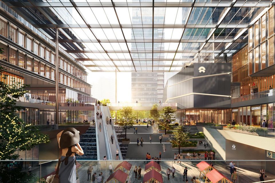 Innenvisualisierung eines großzügigen Atriums mit mehrgeschossigen Galerieebenen, überdachter Platzsituation, Treppenanlagen und vielfältigen Aufenthaltsbereichen.