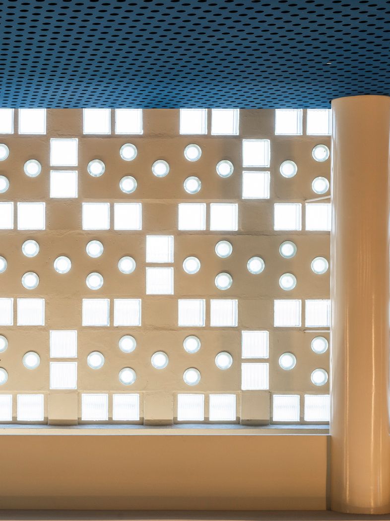 Geometrische Wandstruktur mit runden Öffnungen in einem modernen Innenraum